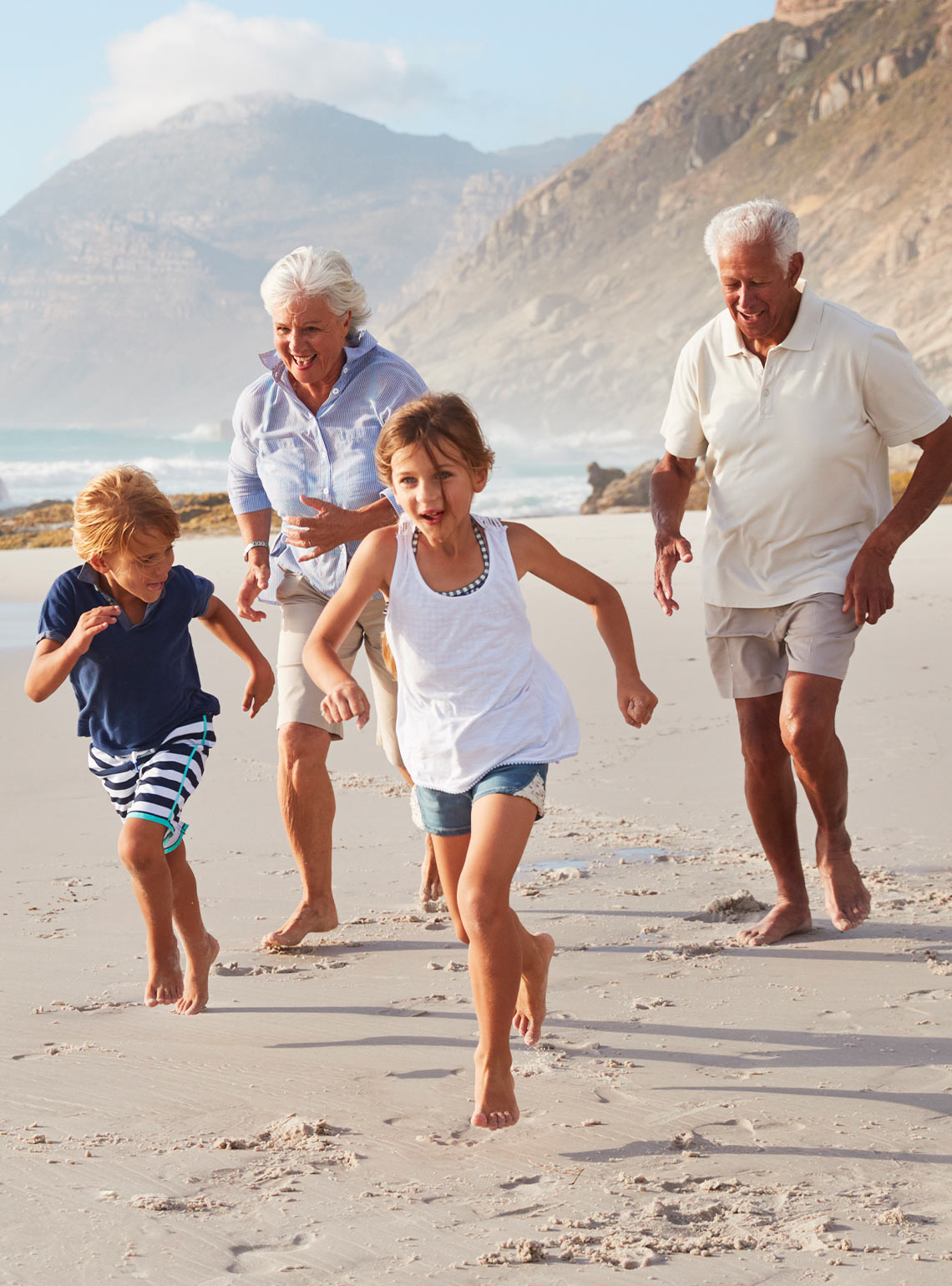 grandparents running on the beach with their grandkids keys to a successful retirement destin fl
